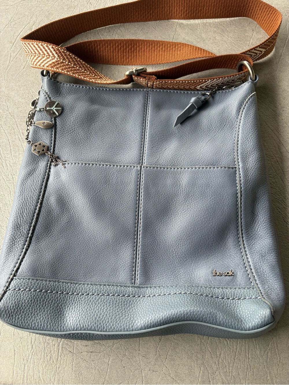 The Sak Light Blue Pebbled Leather Crossbody with Tan Woven Strap